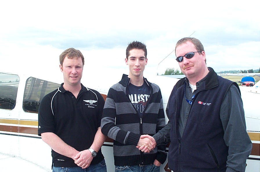 Alex (John) Birch receives congratulations from Pilot Examiner Peter Cox and Flight Instructor Darren Ferguson on May 30, 2008.  Langley Flying School.